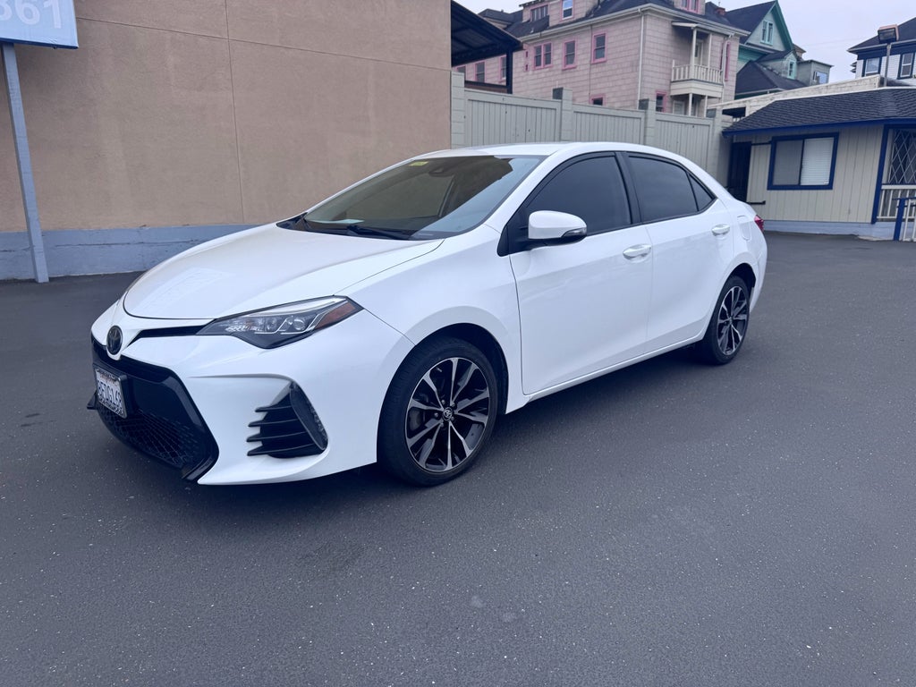 2019 Toyota Corolla L in White — front three-quarter view